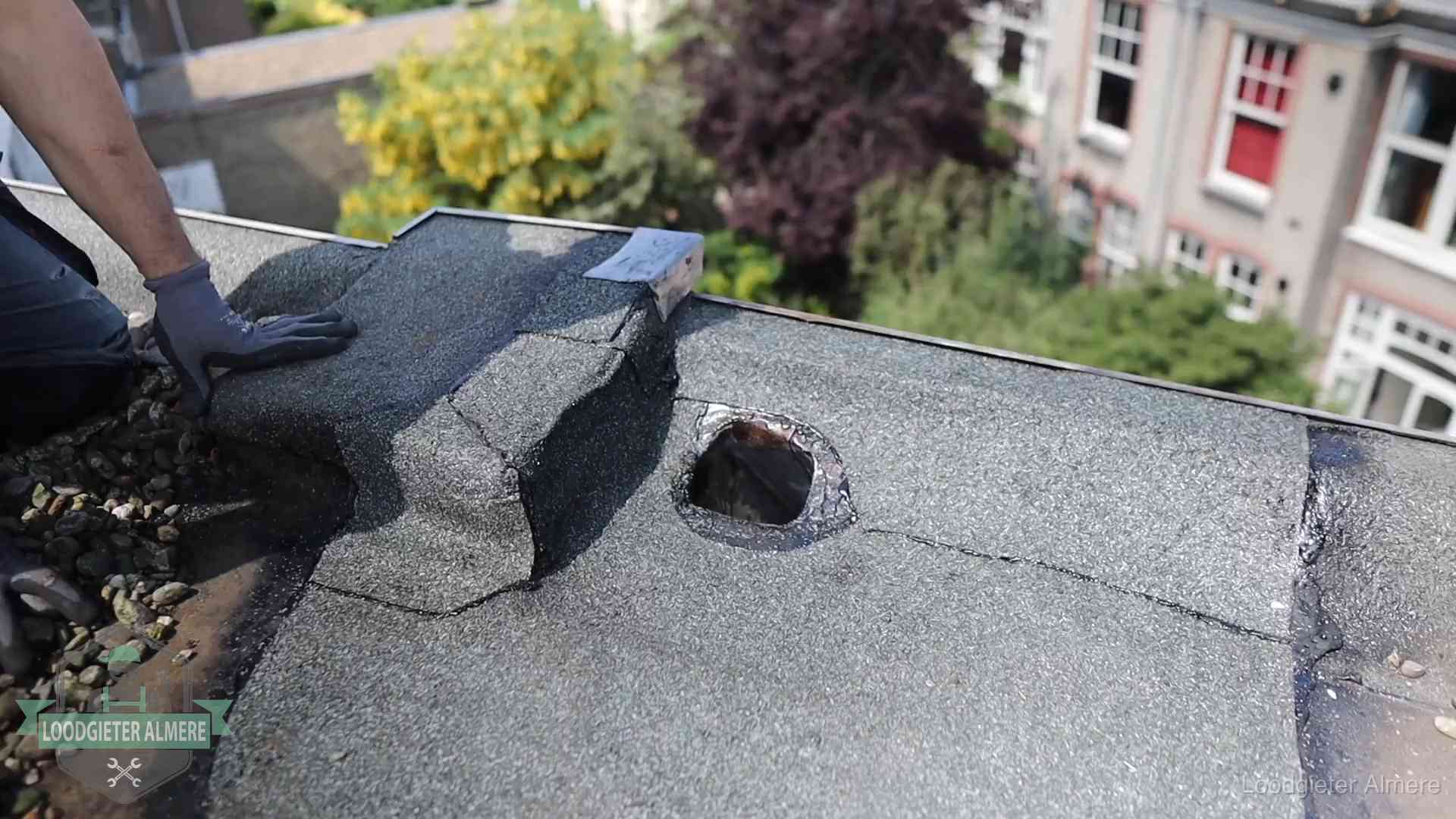 Daklekkage-inspectie op een plat dak in Almere Loodgieter inspecteert een beschadigd bitumen plat dak tijdens een daklekkage-inspectie in Almere